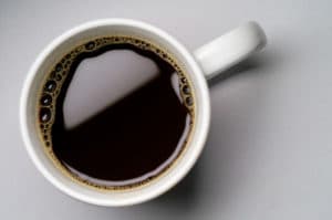 Coffee cup on grey background (seen from above)