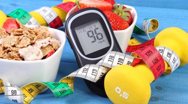 Glucometer with sugar level, healthy food, dumbbells and centimeter, diabetes type 1 diabetes